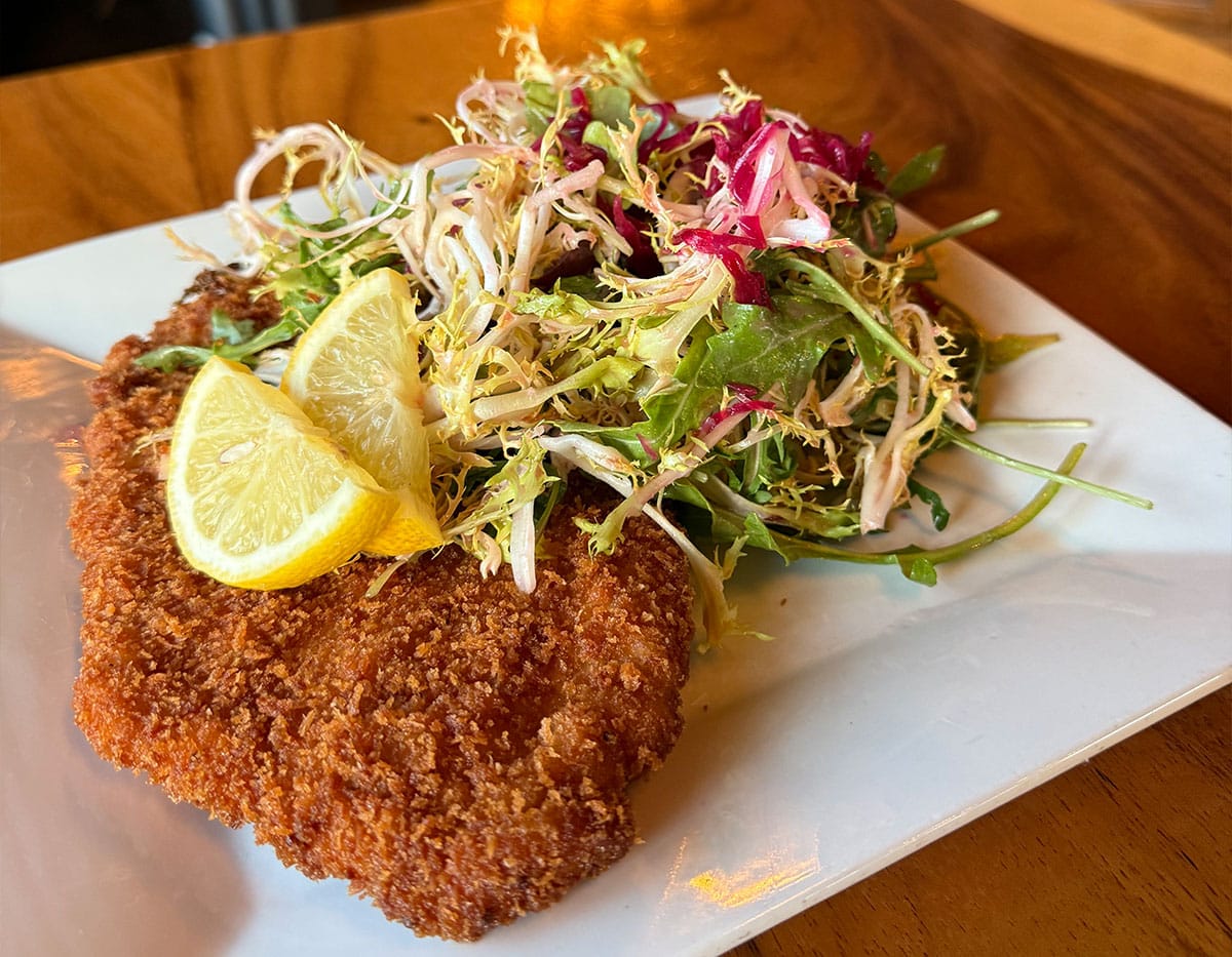 Encrusted pork cutlet with a side salad