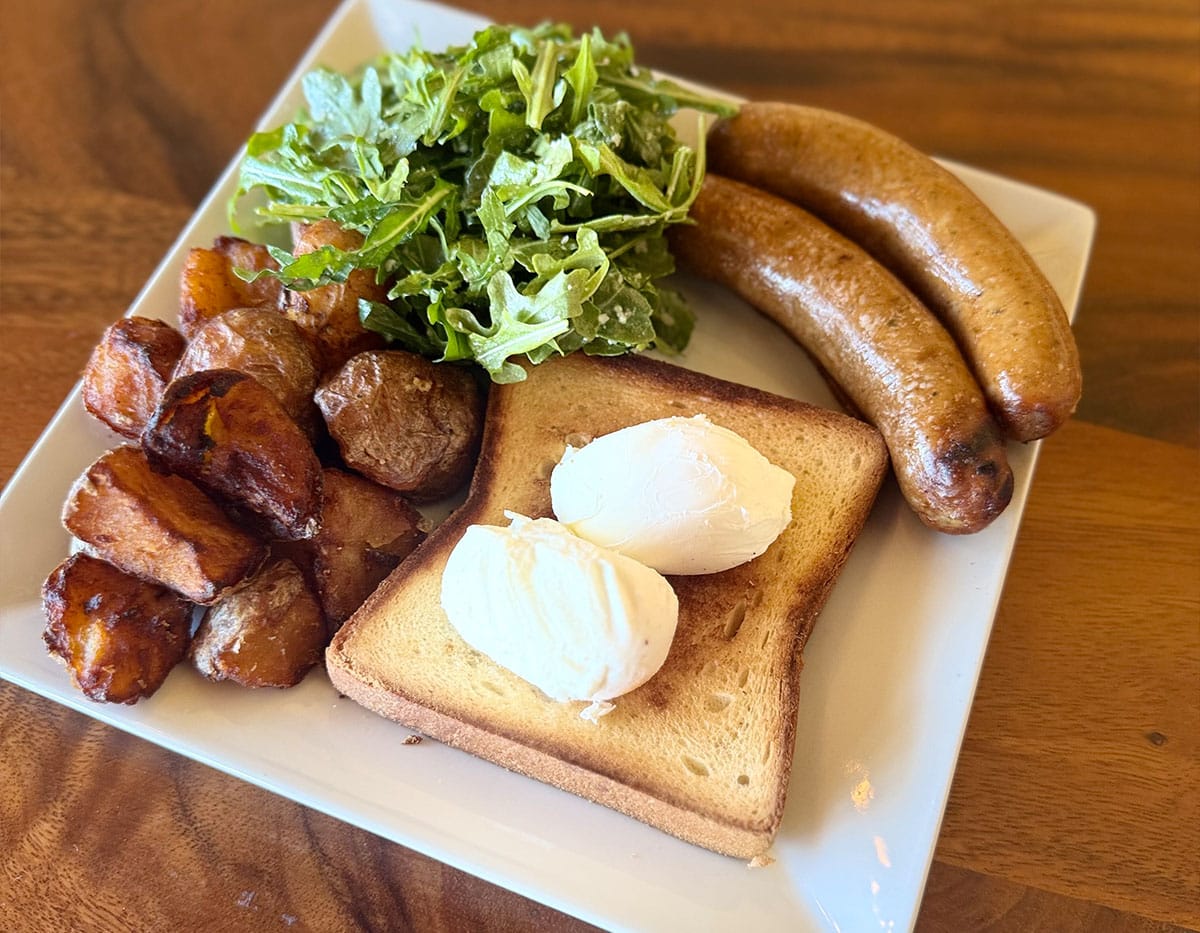 Roasted potatoes with sausage and toast with poached eggs